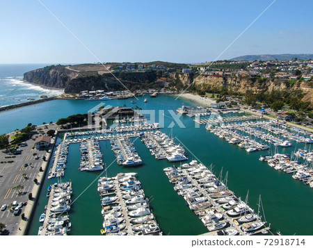 Aerial view of Dana Point Harbor and her marina with yacht and sailboat. Aerial view of Dana Point Harbor and her marina with yacht and sailboat. 72918714