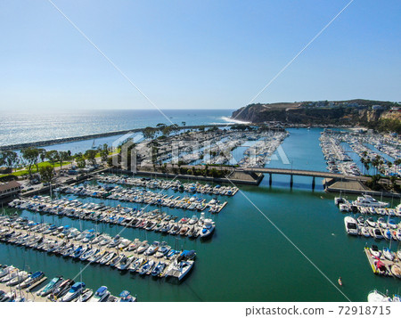 Aerial view of Dana Point Harbor and her marina with yacht and sailboat. 72918715