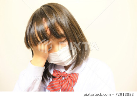 Girl wearing a mask, unwell, coughing, sneezing, fever Girl wearing a mask, unwell, coughing, sneezing, fever 72918888