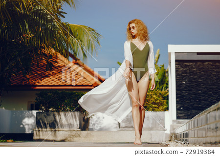 blonde girl relaxing at the pool blonde girl relaxing at the pool 72919384