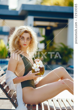 girl drinking fresh juice from a coconut girl drinking fresh juice from a coconut 72919385