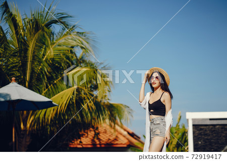 brunette girl relaxing at the pool brunette girl relaxing at the pool 72919417