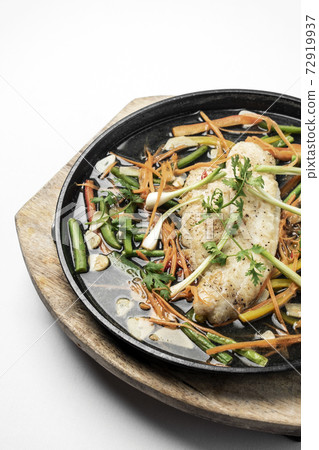 chinese style steamed fish fillet with vegetables on hot plate chinese style steamed fish fillet with vegetables on hot plate 72919937