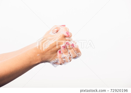 Woman washing hands by soap for cleanliness 72920196