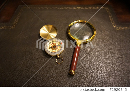 Compass and magnifying glass on the desk Compass and magnifying glass on the desk 72920843
