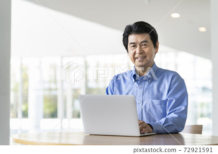 Senior man working on a laptop Senior man working on a laptop 72921591