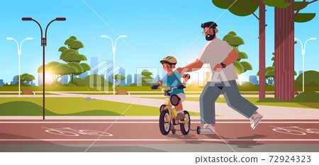 father teaching little son to ride bike in urban park parenting fatherhood concept dad spending time with kid 72924323