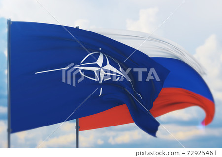 A NATO flag waving next to a Russian flag, representing the growing tension in Europe.