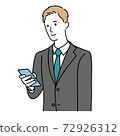 A man in a suit operating a smartphone 72926312