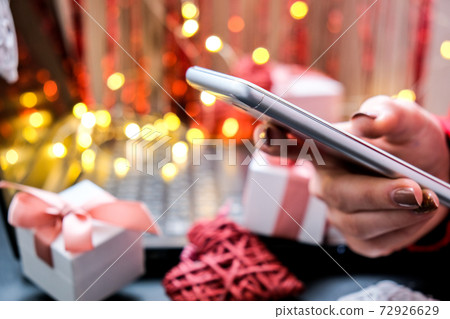 Mobile phone in hand. Mobile applications. Online promotions and discounts. Holiday gifts and surprises. Present. Valentine's Day. Internet technologies. Shopping 72926629