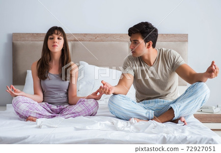 Young family meditating in the bed bedroom Young family meditating in the bed bedroom 72927051