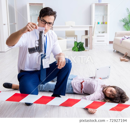 Forensic investigator at the crime scene investigating woman mur Forensic investigator at the crime scene investigating woman mur 72927194