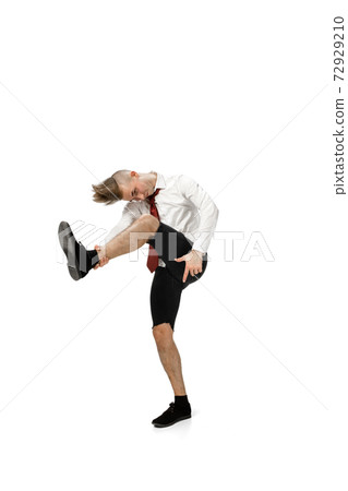 Happy young man dancing in casual clothes or suit, remaking legendary moves of celebrity from culture history Happy young man dancing in casual clothes or suit, remaking legendary moves of celebrity from culture history 72929210