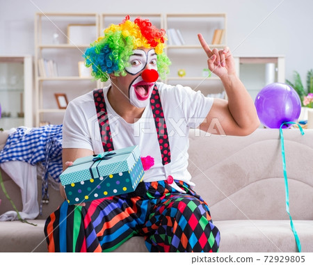 Drunk clown celebrating having a party at home 72929805