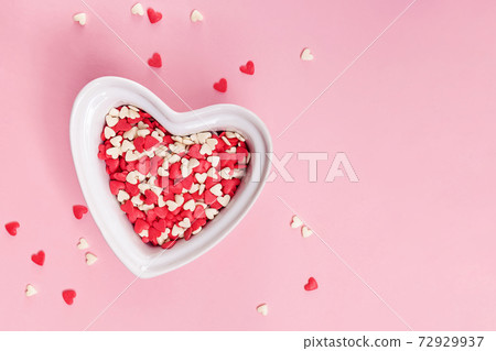 Heart shaped bowl filled with sugar sprinkles Heart shaped bowl filled with sugar sprinkles 72929937