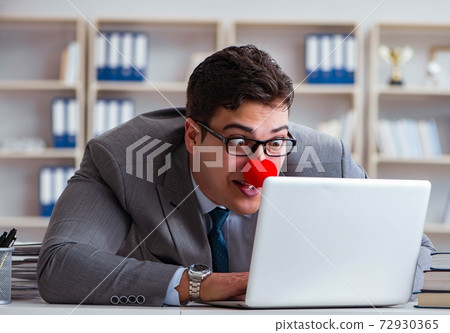 Clown businessman working in the office 72930365