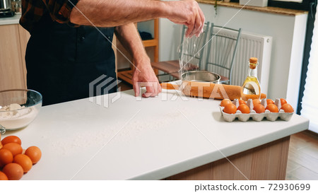 Making dough by man hands at home Making dough by man hands at home 72930699