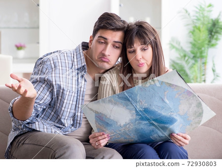Young family discussing travel plans with map Young family discussing travel plans with map 72930803