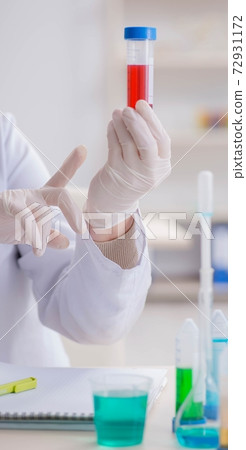 Woman doctor checking blood samples in lab Woman doctor checking blood samples in lab 72931172