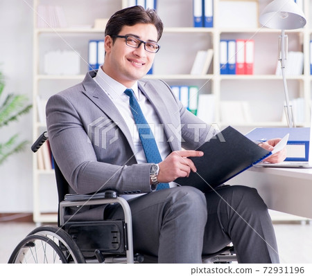 Disabled businessman working in the office Disabled businessman working in the office 72931196
