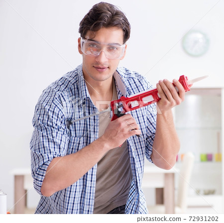 Young man in woodworking hobby concept 72931202