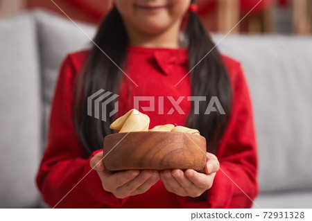 Girl Holding Fortune Cookies 72931328