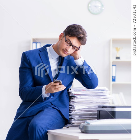 Businessman making copies in copying machine Businessman making copies in copying machine 72931343