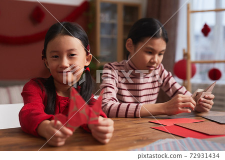 Asian Girls Making Paper Cranes 72931434