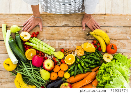 Table view of coloured mix of fresh and seasonal fruits and vegetables for vegan or vegetarian or just heathy food - diet and weight loss ingredieents - housewife chef ready to cook at home Table view of coloured mix of fresh and seasonal fruits and vegetables for vegan or vegetarian or just heathy food - diet and weight loss ingredieents - housewife chef ready to cook at home 72931774