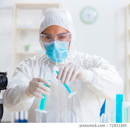 Young chemist student working in lab on chemicals Young chemist student working in lab on chemicals 72931895