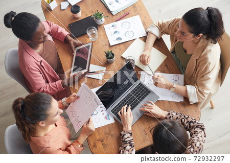 Team of Businesswomen Brainstorming at Meeting Table Team of Businesswomen Brainstorming at Meeting Table 72932297