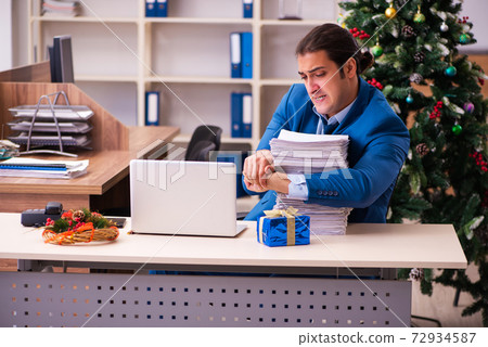 Young male employee working in the office at Chrismas 72934587