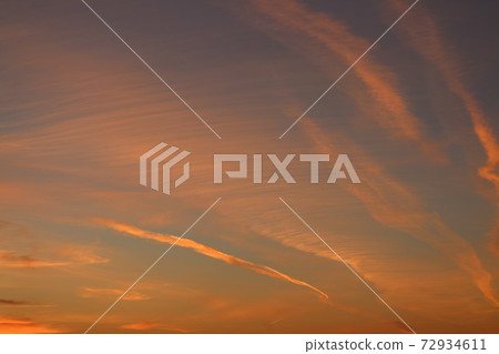 Red aircraft trails in the sky 72934611