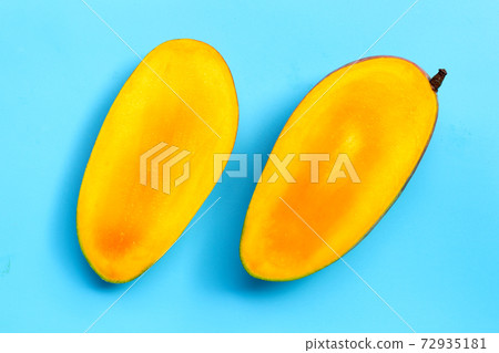 Mango on blue background. Tropical sweet fruit concept. Mango on blue background. Tropical sweet fruit concept. 72935181