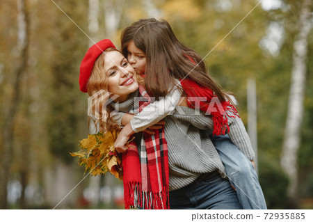 Cute and stylish family in a autumn park Cute and stylish family in a autumn park 72935885