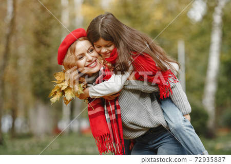 Cute and stylish family in a autumn park 72935887