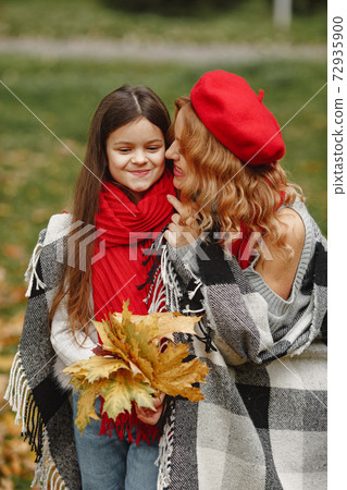 Cute and stylish family in a autumn park 72935900
