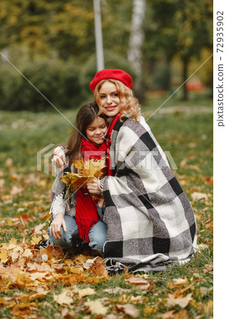 Cute and stylish family in a autumn park 72935902