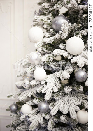 Christmas tree with white and silver balls and garlands 72936197