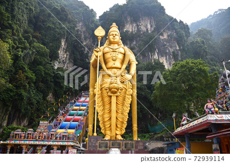 Entrance to Batu Caves with the giant, golden Murugan statue and the 272-step colorful staircase Entrance to Batu Caves with the giant, golden Murugan statue and the 272-step colorful staircase 72939114