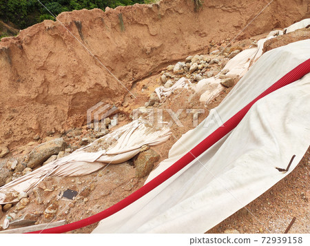 Landslide because of heavy rain. The landslides destroy the underground utility pipes and some man build structures.  72939158