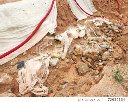 Landslide because of heavy rain. The landslides destroy the underground utility pipes and some man build structures.  72939164