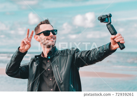 Handsome Guy Making Selfie at the Beach Handsome Guy Making Selfie at the Beach 72939261