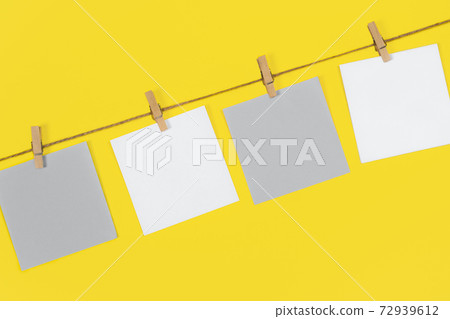 Note papers and decorative pin or clip isolated on yellow background. Office mock up. Note papers and decorative pin or clip isolated on yellow background. Office mock up. 72939612