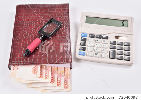 The lucrative business partners: money, calculator, calendar, magnifier 72940098
