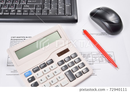 Desk accountant closeup: invoice, keyboard, calculator, mouse, and red pen 72940111