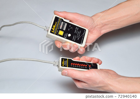 Hands of the installer Ethernet LAN check tester for twisted pair Hands of the installer Ethernet LAN check tester for twisted pair 72940140