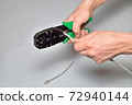Hands of an electrician cut off the computer twisted pair tongs 72940144