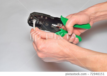 Hands of the installer, computer network, fix the connector on t 72940151