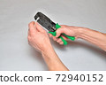 Hands of the installer of computer networks ticks crimped connec 72940152